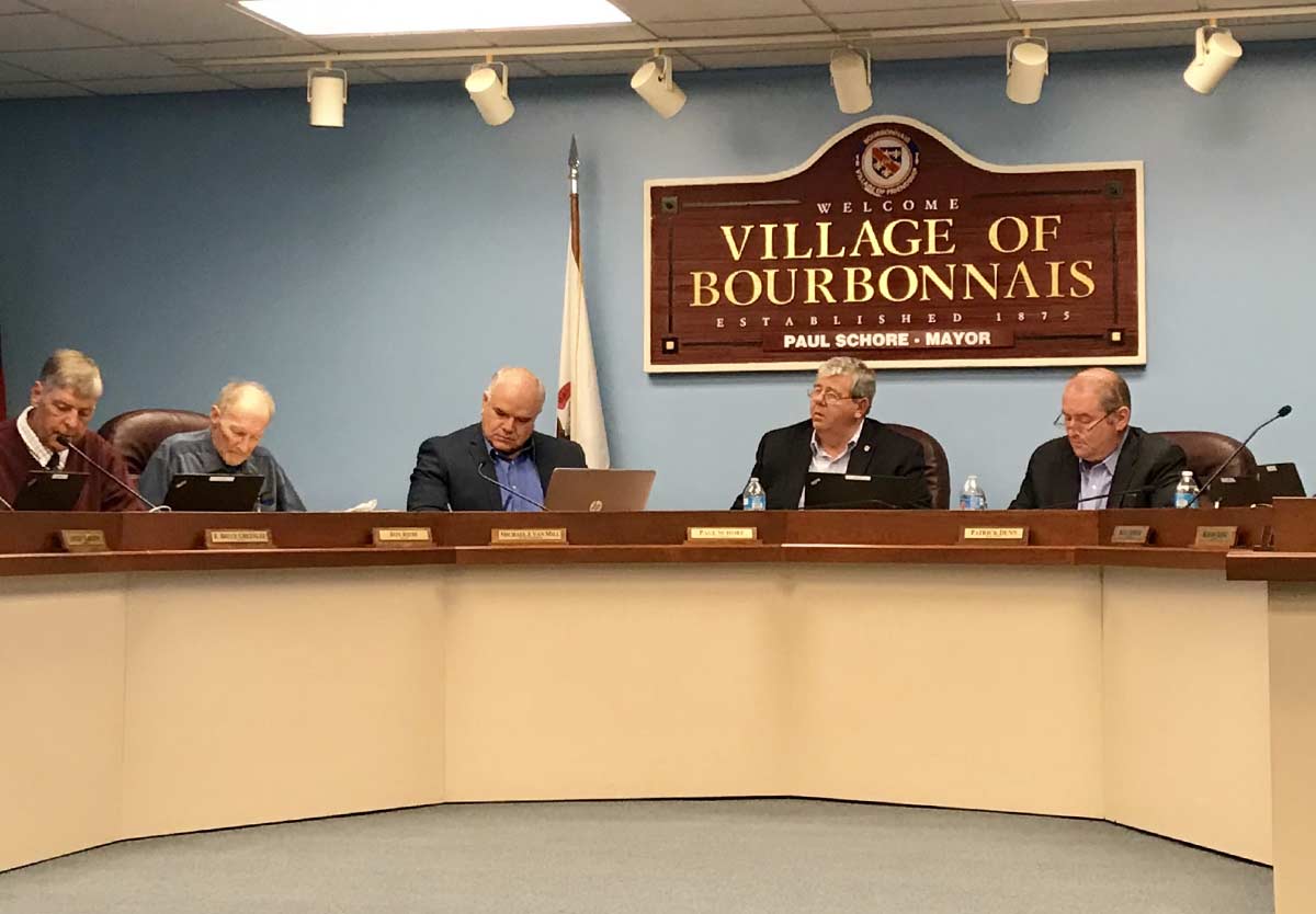 village of bourbonnais village board meeting inside administrative building with Mayor Paul Schore at the center