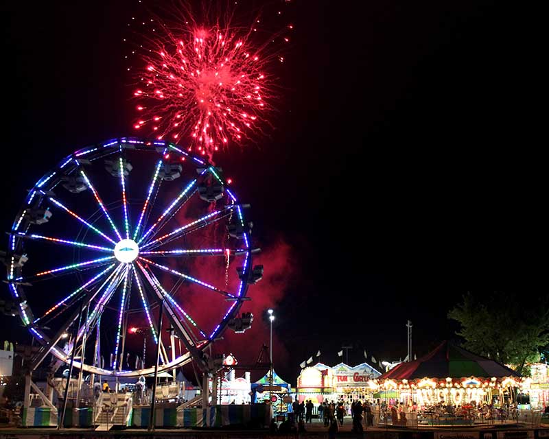 firework and ferris wheel at night during friendship festival